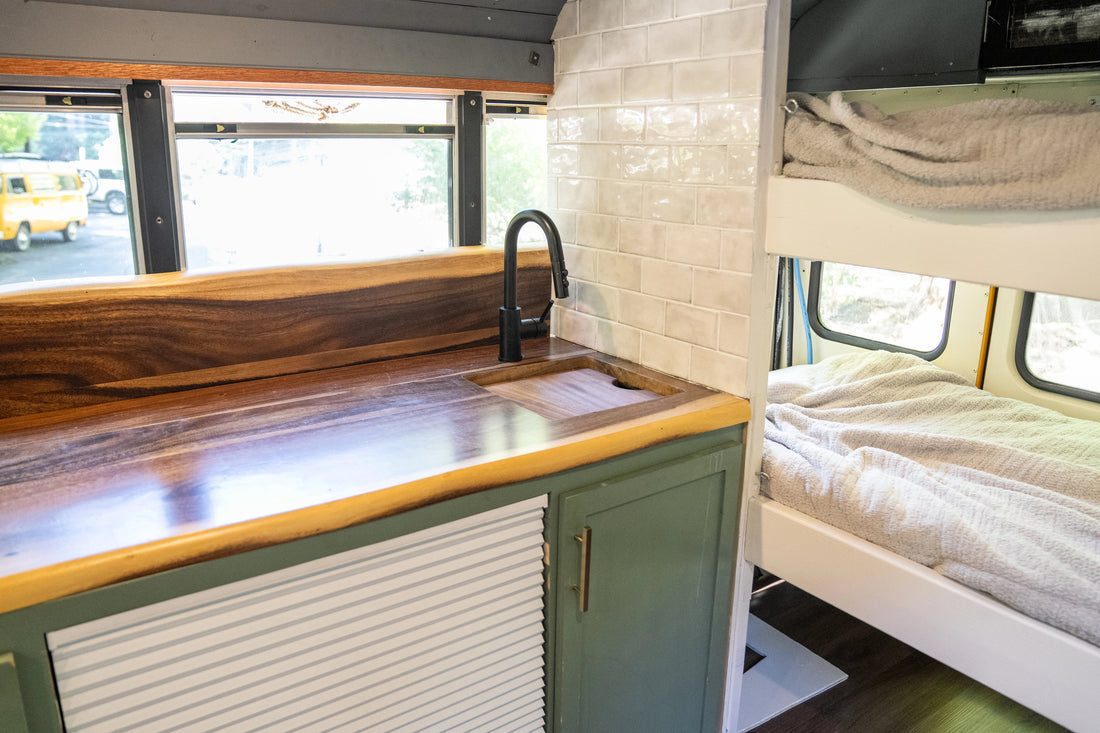 showing inside the van life bus, near the kitchen and the bed.