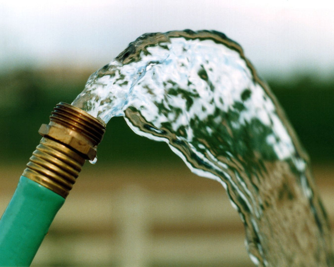 a hose releasing water while being used by a vanlifer
