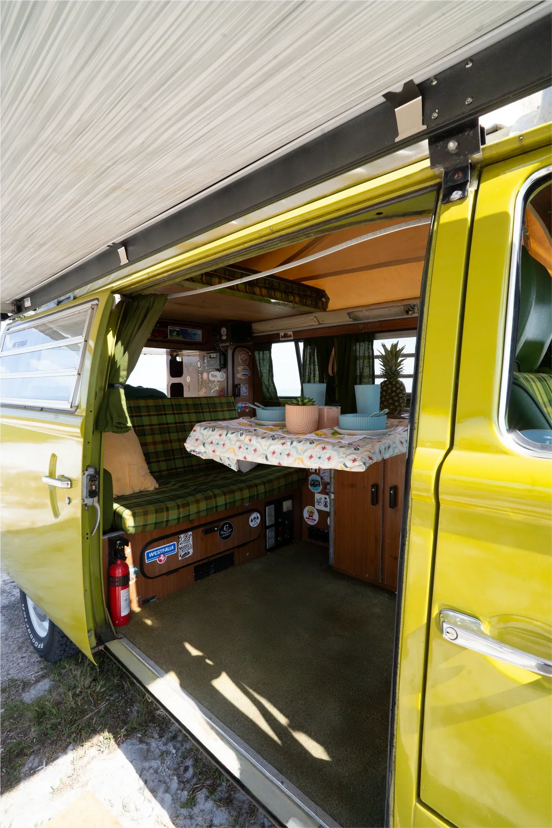 vanlife kiwi van with door opened at the beach