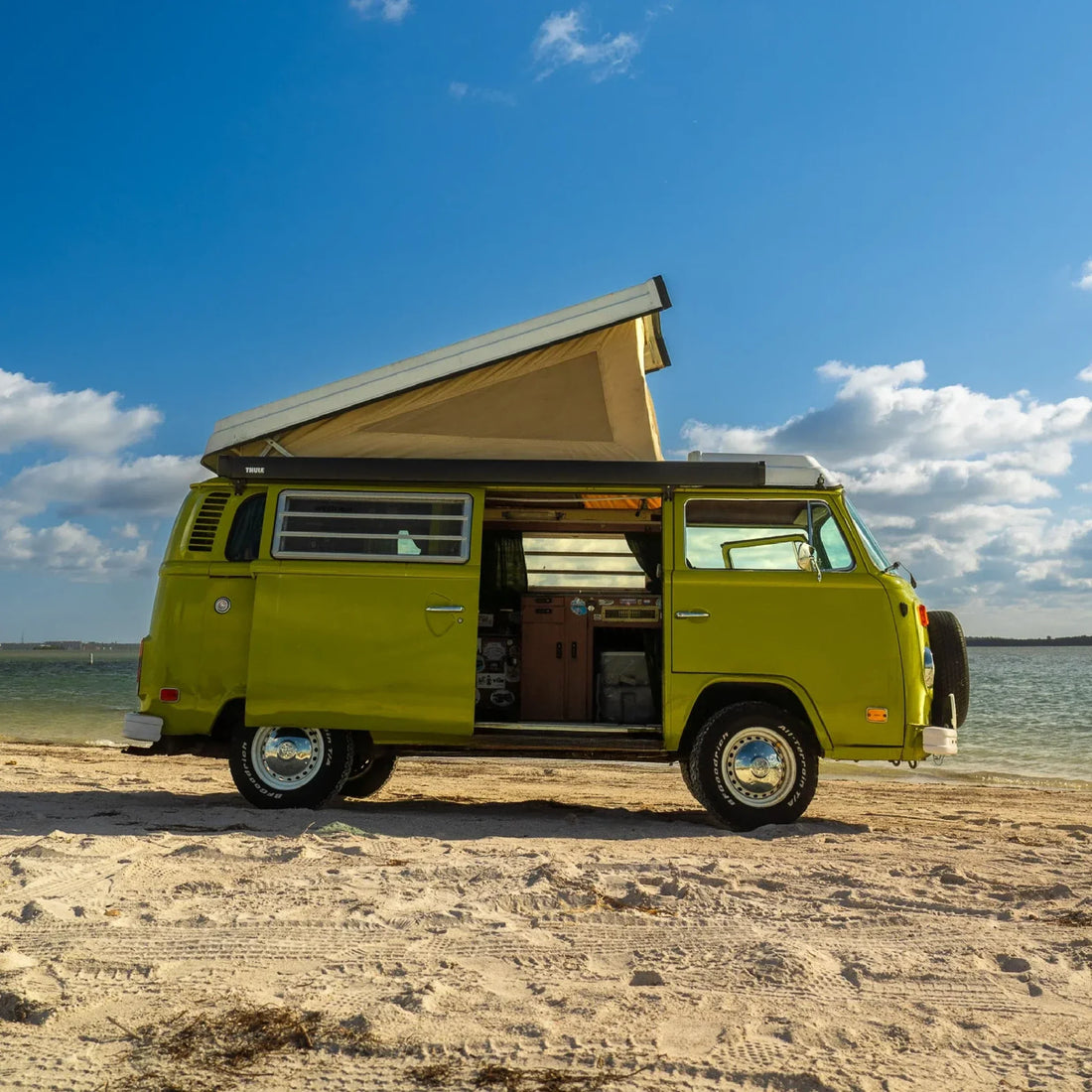 vanlife kiwi volkwagen camper van side view parked on the sand at the beast