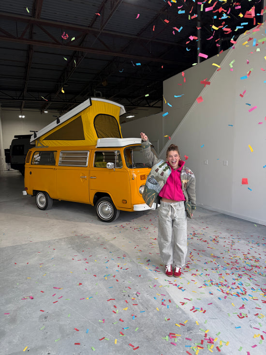 Vanlife volkswagen mango van winner standing next her van with confetti falling around her