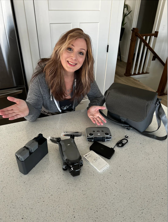 VanLife DJI Air 3 Drone Winner celebrating at her kitchen counter.