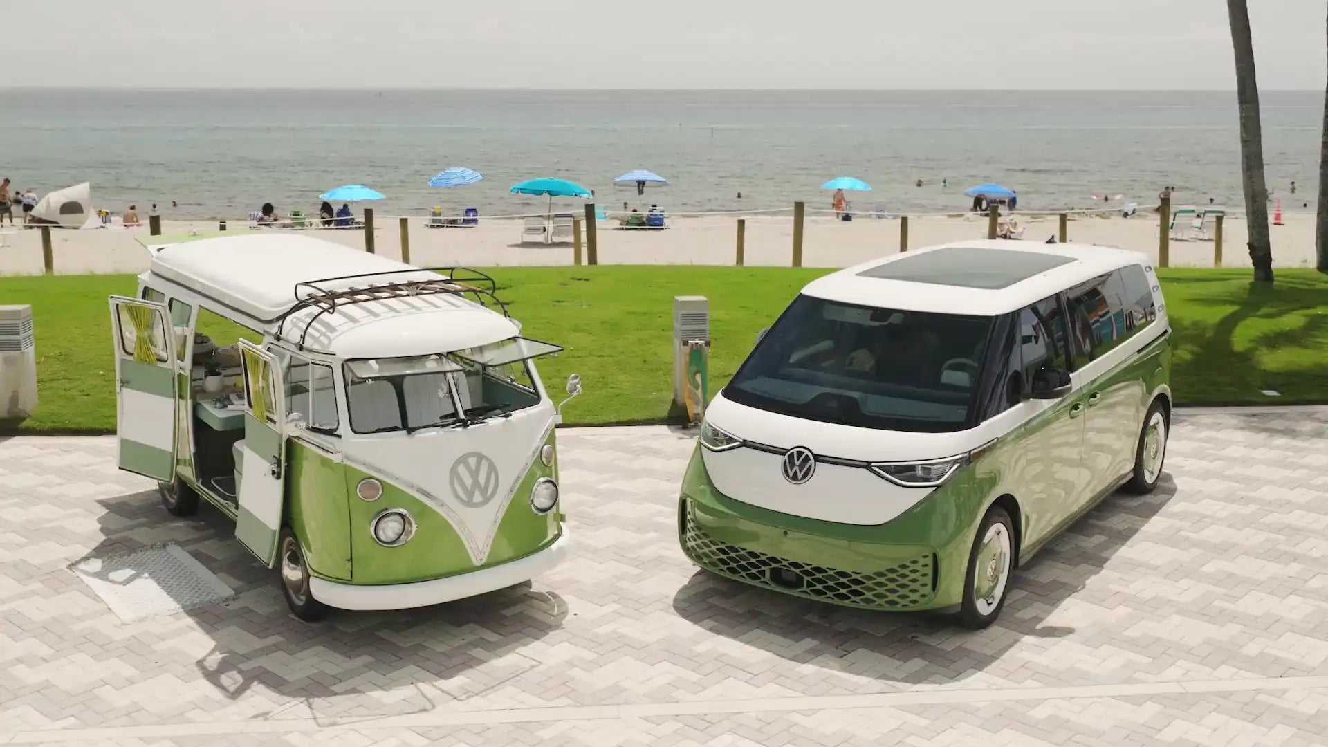 A restored 1972 VW Bus Camper beside a 2025 electric VW ID. Buzz