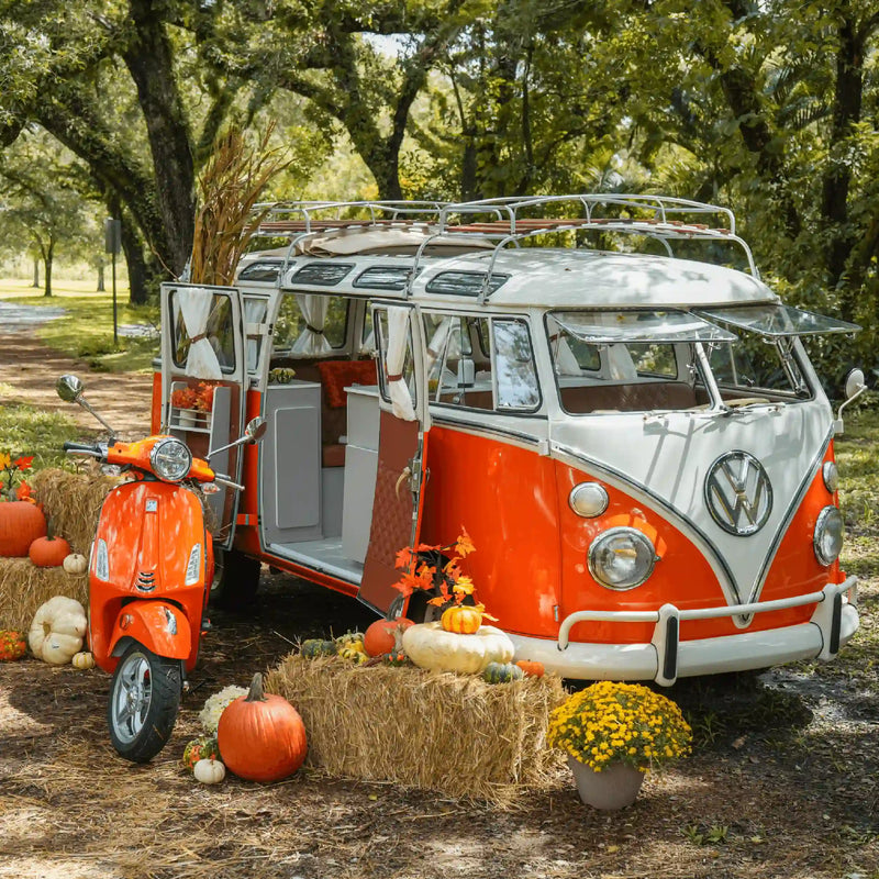 The orange Bus and Vespa among hay bales and pumpkins