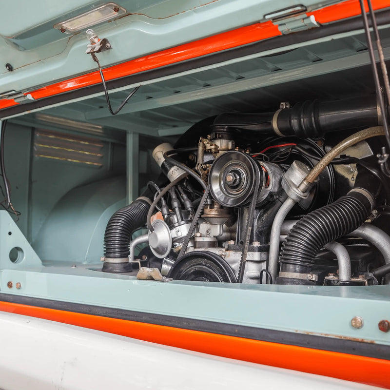 The open rear engine compartment of the prize Bus, with the air-cooled engine inside and pale blue paint around it