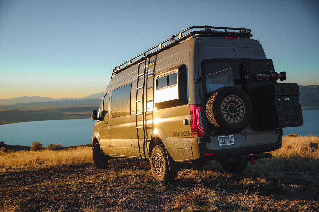 Van life Sprinter van parked on a grassy field overlooking a lake